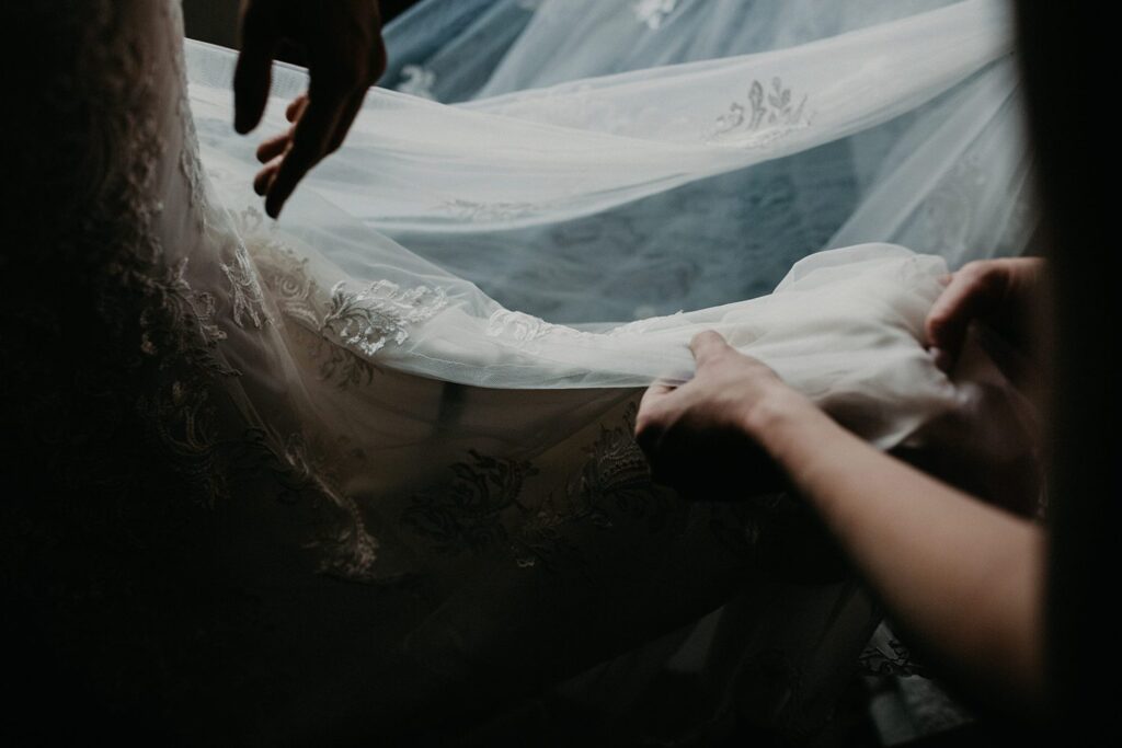 A bride in Los Angeles, captured by a wedding photographer, gracefully adorns her wedding dress.