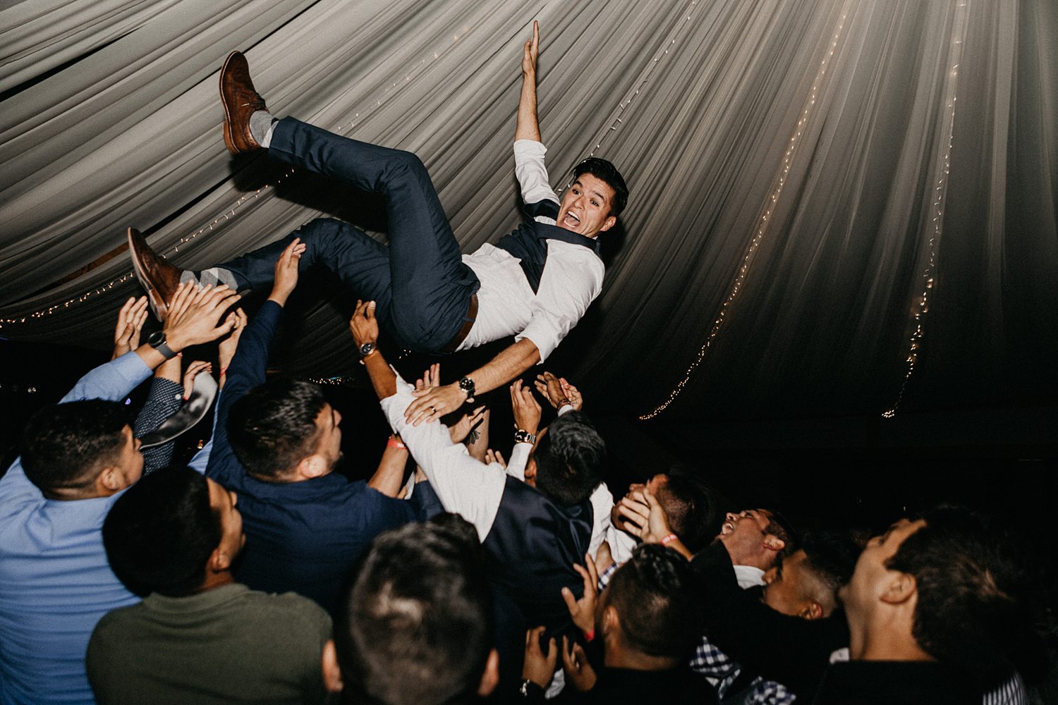 groom being thrown in the air